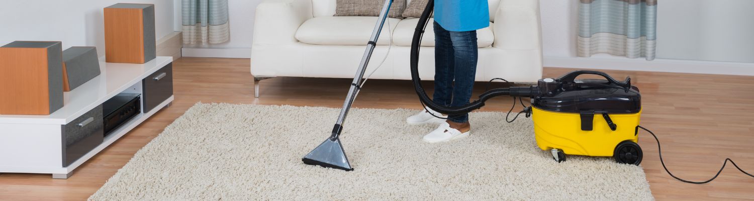 Carpet Cleaner on a beige rug with a yellow steam vacuum